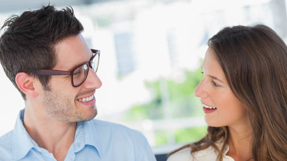 Man and woman smiling at each other