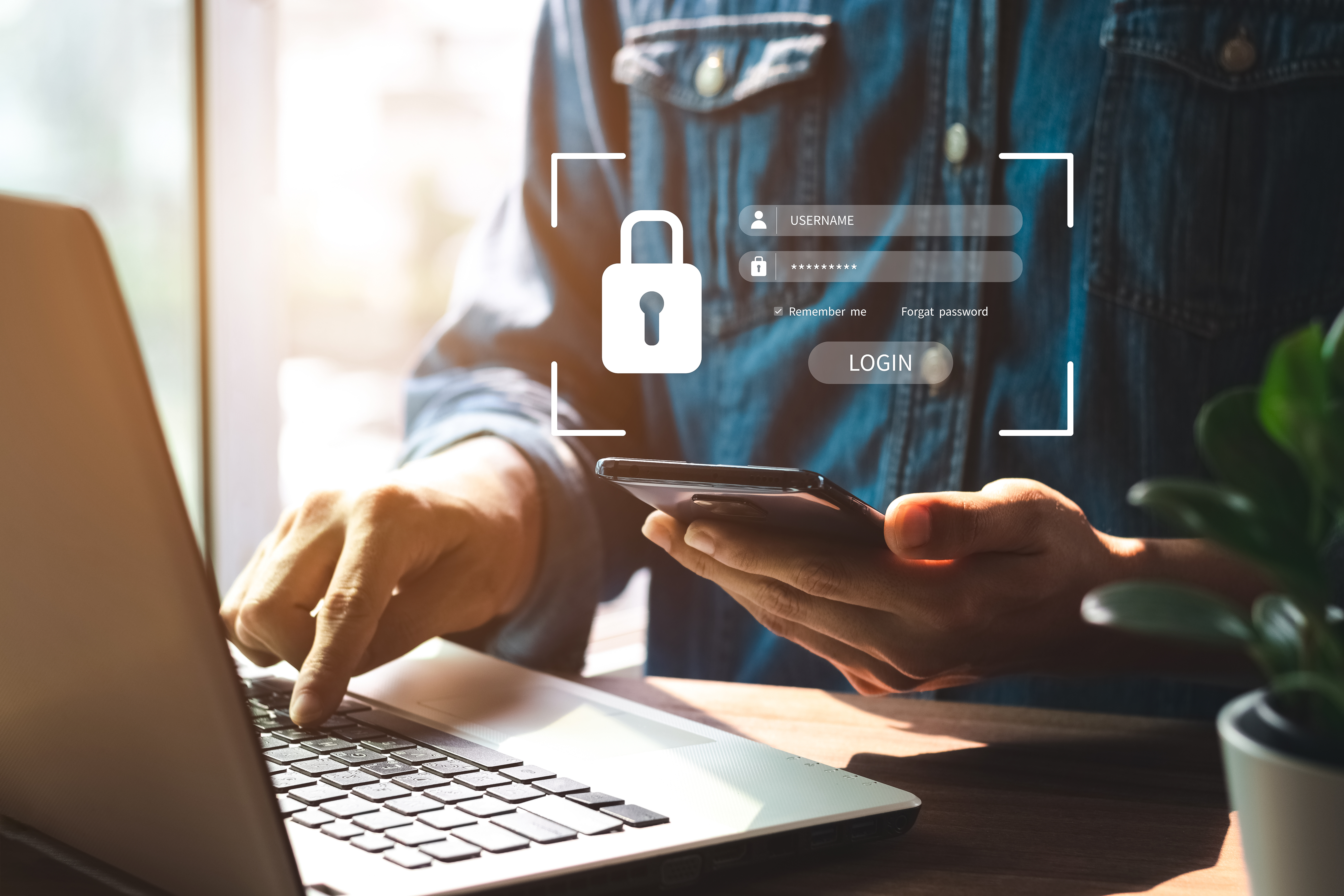 A futuristic image of a man with a phone and a laptop providing cybersecurity for schools.