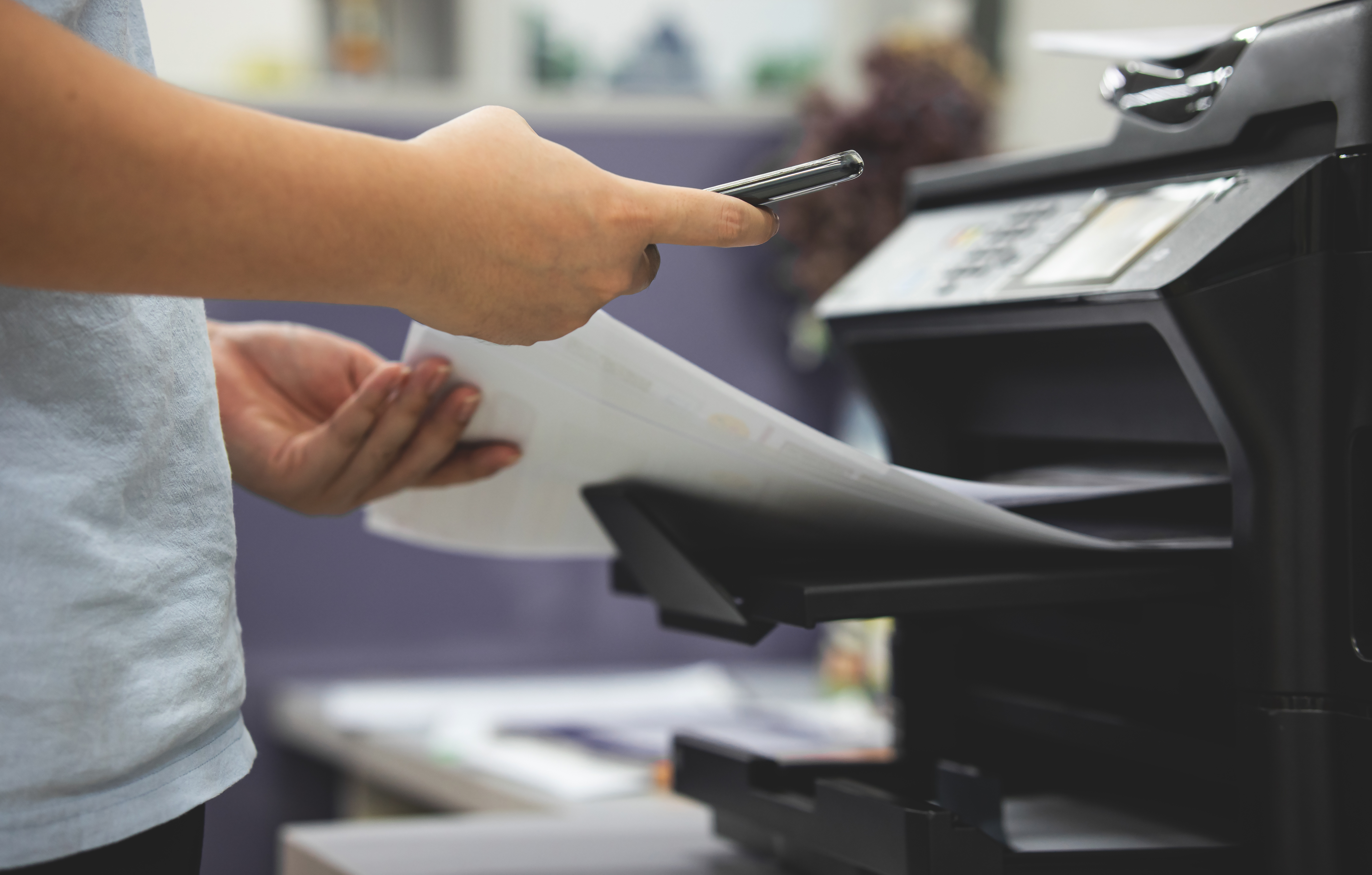 An image of a worker using managed print services at an accounting firm.