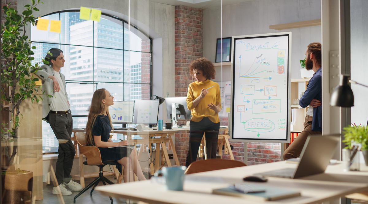 woman pointing at digital whiteboard